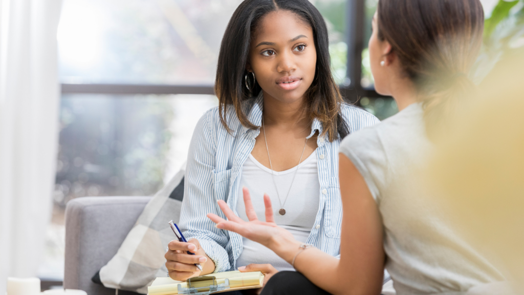 A young teen talks about her mental health with a therapist at Strive.