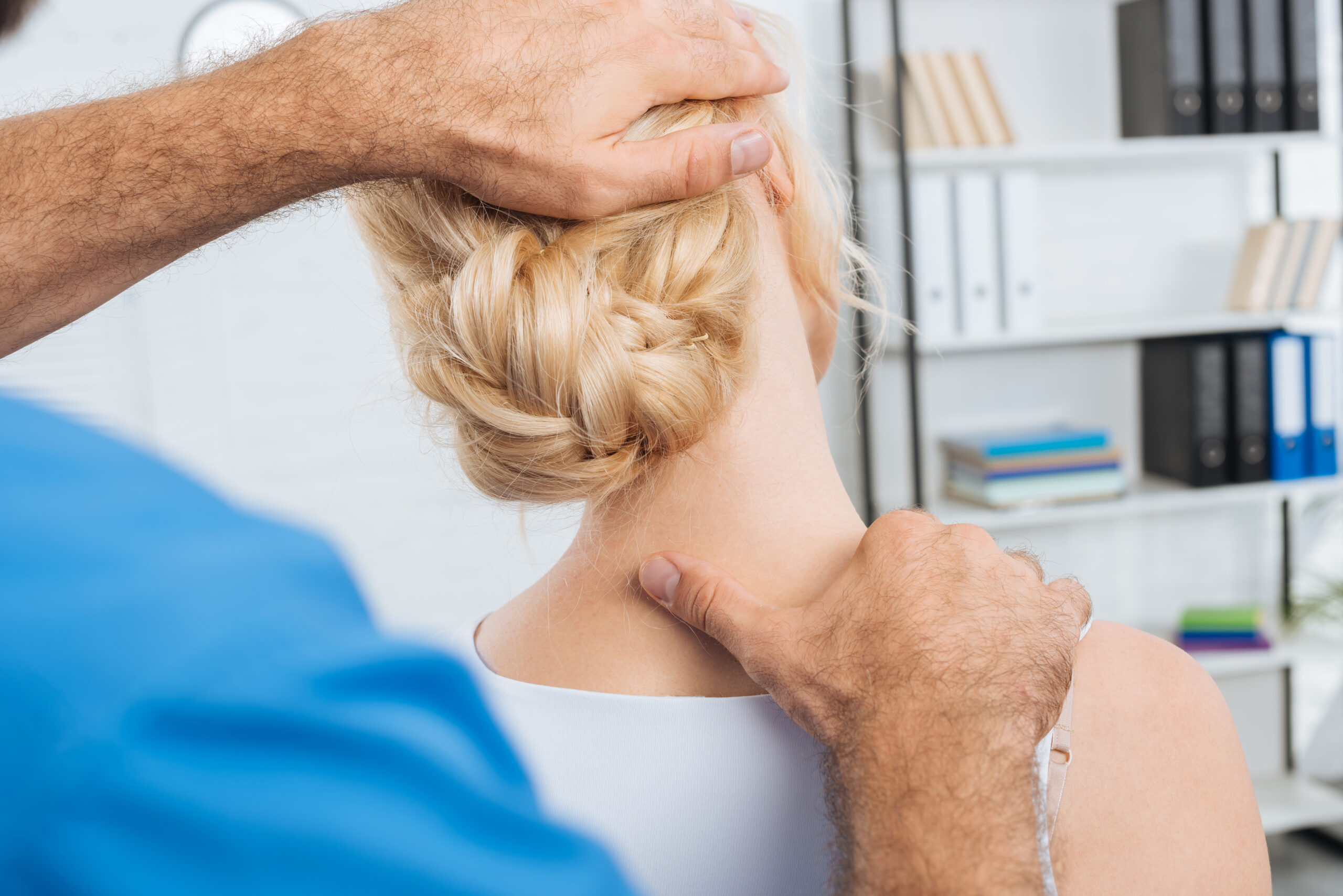 Chiropractor assessing a patient's neck posture at a Coquitlam clinic